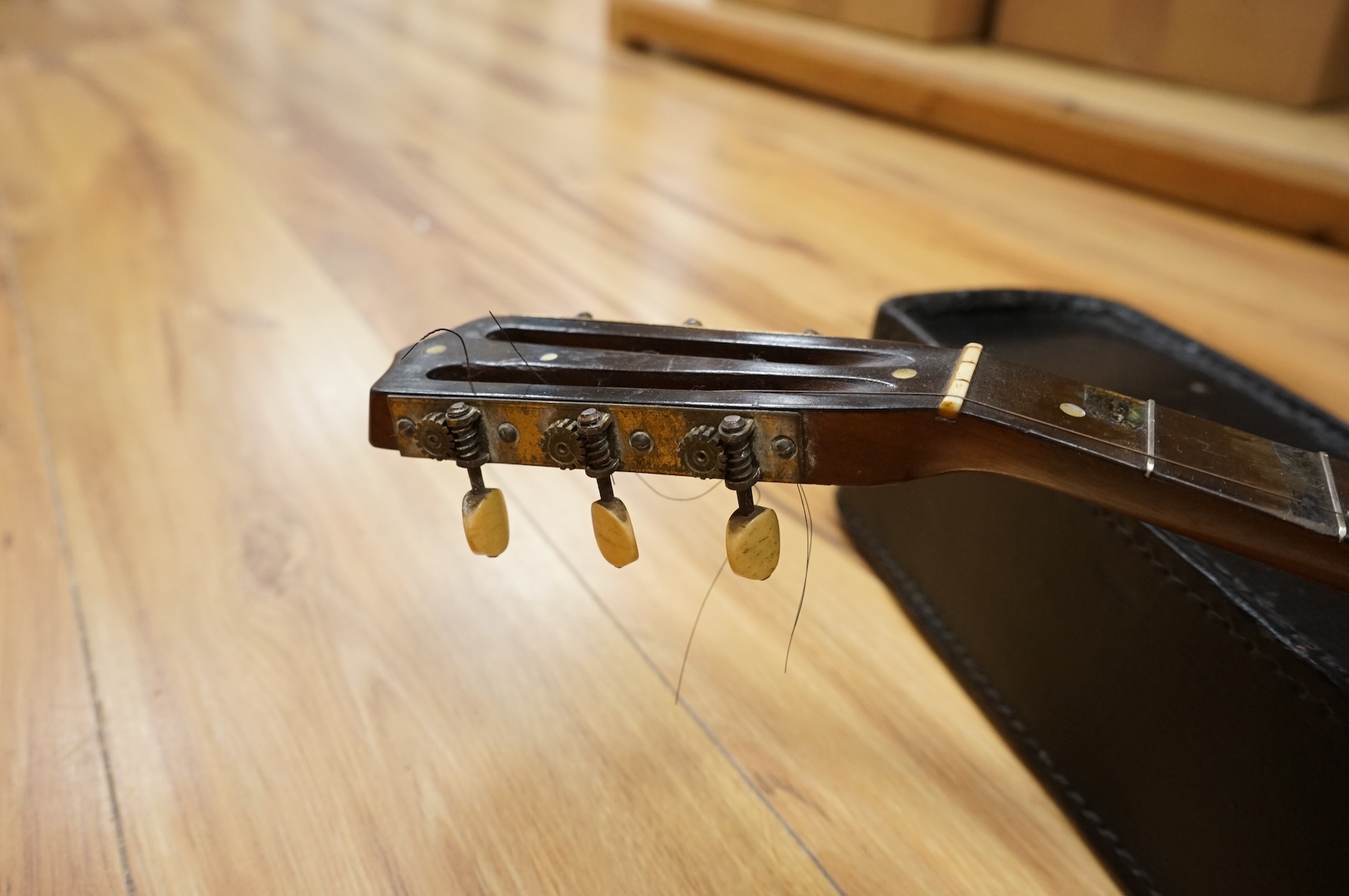 A rosewood banjo with mother of pearl inlay, cased